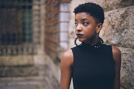 woman standing against concrete wall in shallow focus shot thumbnail