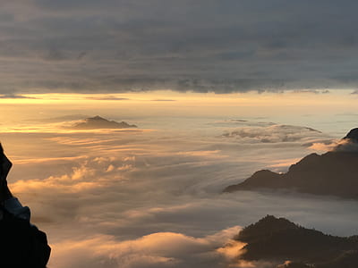cloud-covered mountaintops during sunset thumbnail