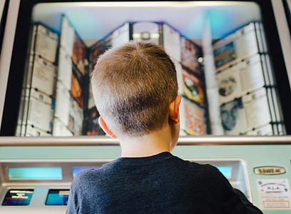 boy wearing black shirt facing machine thumbnail