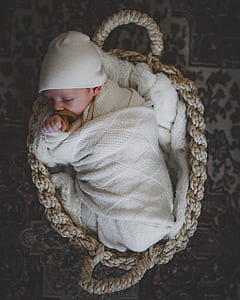baby sleeping on basket thumbnail
