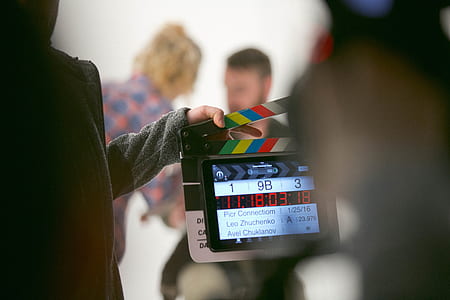 person holding black film clapper thumbnail