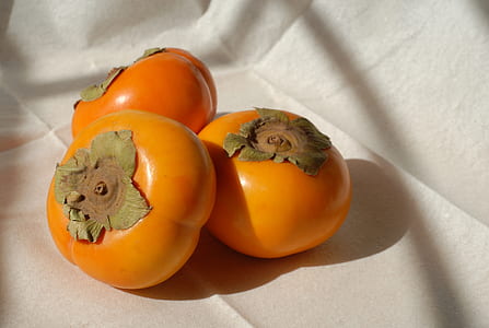 three orange vegetables on white textile thumbnail