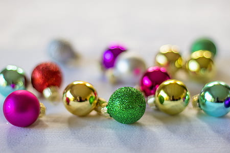 assorted-color baubles on white textile thumbnail