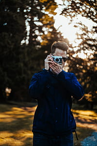 selective focus photography of man using MILC thumbnail