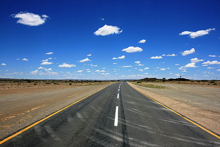 black concrete road under blue sky thumbnail