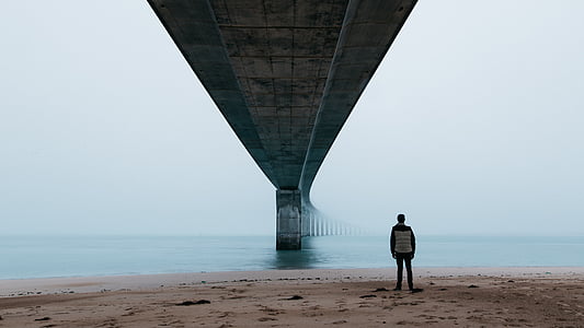 person standing under bridge thumbnail