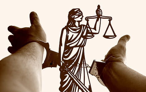 silver handcuffs on person hands thumbnail