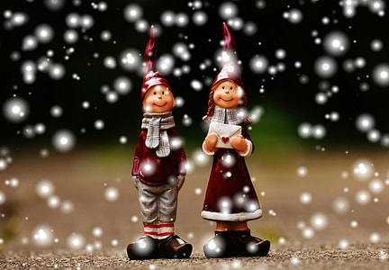 two boy and girl standing wearing Santa hat figurines thumbnail