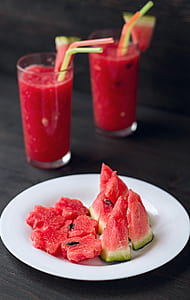sliced watermelon on white plate thumbnail
