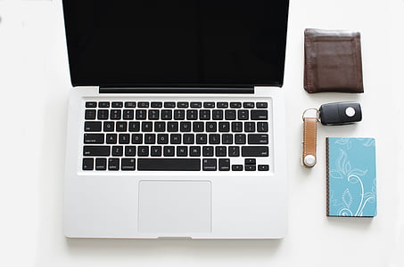 turned off MacBook Pro beside black vehicle fob and brown leather wallet thumbnail