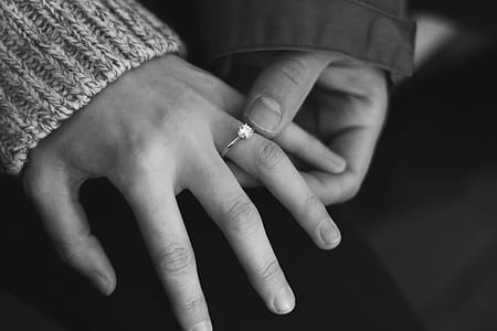 grayscale photography of person holding ring thumbnail