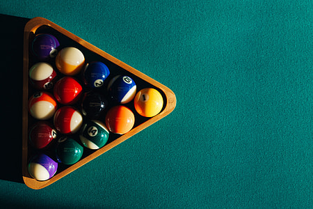 Billiard balls on green table with billiard cue thumbnail