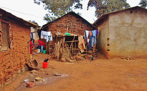 assorted apparels hung in front of brown house thumbnail
