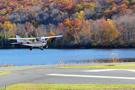 A Cessna single engine private airplane on the tarmac coming in for a landing. thumbnail