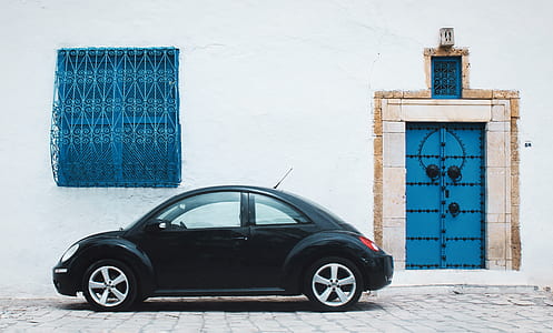 black Volkswagen New Beetle coupe park outside the building thumbnail