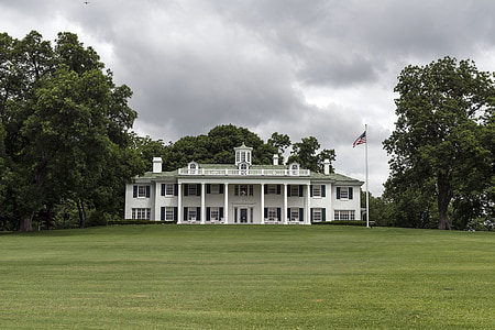 white painted building on green grass field thumbnail