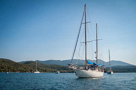 white sail boat on body of water thumbnail