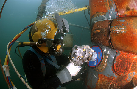person in water holding angle grinder thumbnail