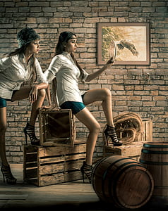 woman sitting on crate holding mirror thumbnail
