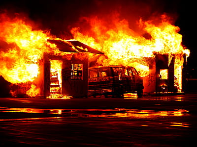 building on fire near body of water thumbnail