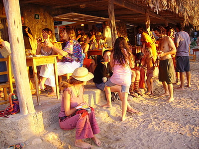 man and woman sits and stand near house thumbnail