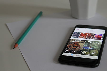 turned-on black iPhone 7 beside pencil thumbnail
