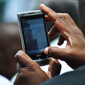 person holding turned-on smartphone thumbnail