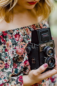 woman holding black camera thumbnail