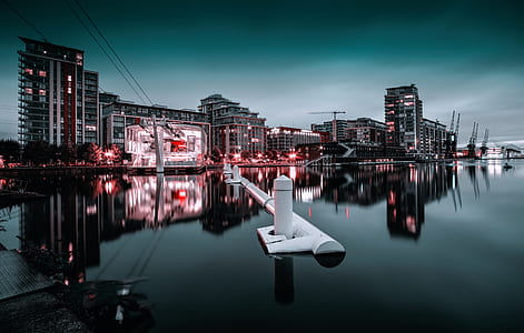 white pipe on body of water towards high-rise building thumbnail