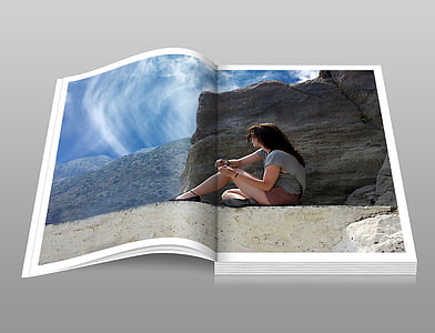 photo of open book page displaying woman sitting near brown rock during day time thumbnail