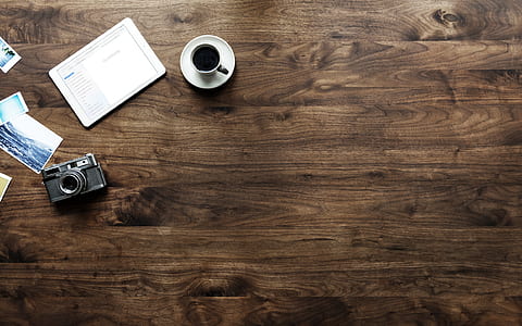 flat lay photography of filled teacup beside camera thumbnail