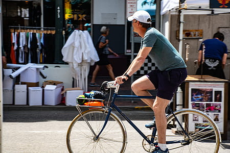 Man Wearing Grey T-shirt Riding Bicycle thumbnail