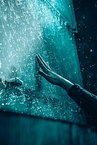 person retching dew water on wall during nighttime thumbnail
