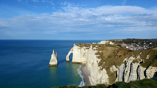 aerial view photography of mountain cliff near body of water at daytime thumbnail