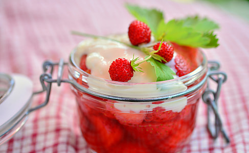 strawberry filled with cream on clear glass bowl thumbnail