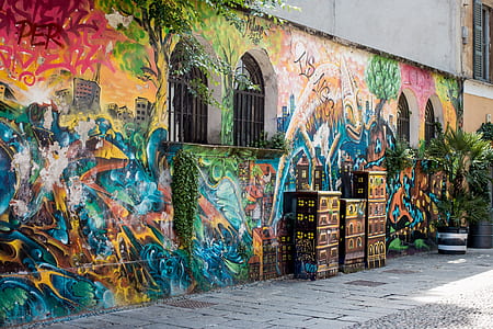 multicolored graffiti on wall beside pavement at daytime thumbnail