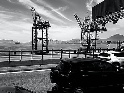 Gray Scale Photo of Black 5-door Hatchback Beside Black Sand Fields thumbnail
