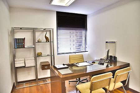 brown wooden executive desk and two vacant chairs thumbnail