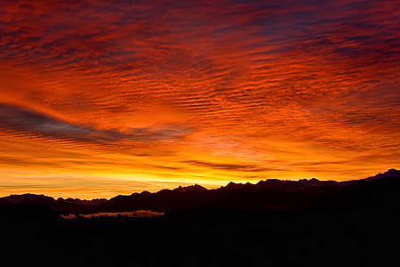 silhouette of mountain under red sea clouds thumbnail