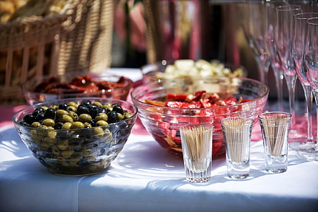 four clear glass bowls beside clear wine glass lot on white table mat thumbnail