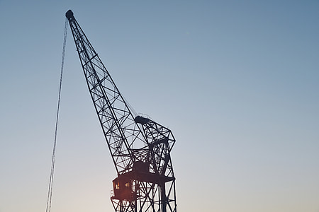 silhouette of crane under clear skies thumbnail