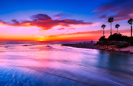photo of seashore near body of water during sunrise thumbnail