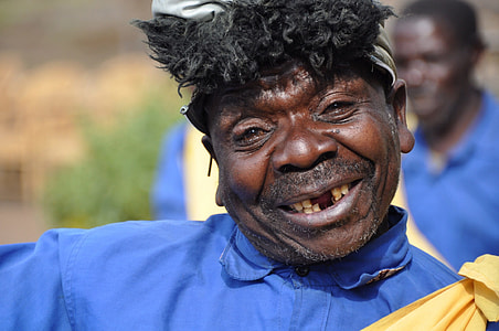 man in blue and yellow collared shirt smiling thumbnail