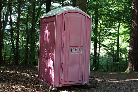 pink portable bathroom on forest during daytime thumbnail