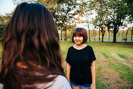 Woman Wearing Black Boat-neck Shirt on Green Grass thumbnail