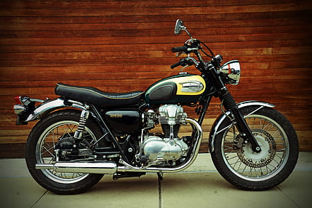 yellow and black standard motorcycle parked near brown wall thumbnail