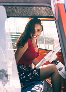 woman wearing red and black dress inside vehicle thumbnail
