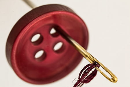 Brass Needle Through Red Cloth Button thumbnail