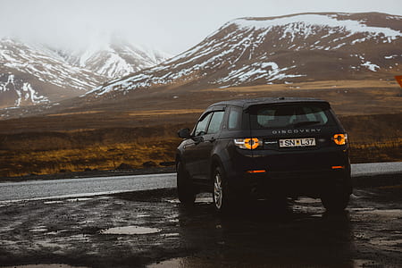 black Land Rover Discovery on the side of the road thumbnail