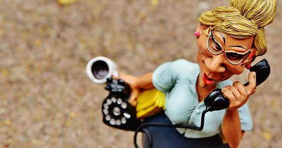 woman holding telephone figurine thumbnail